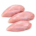 Three pieces of raw chicken breast on a white background
