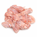 Raw chicken pieces on a white background